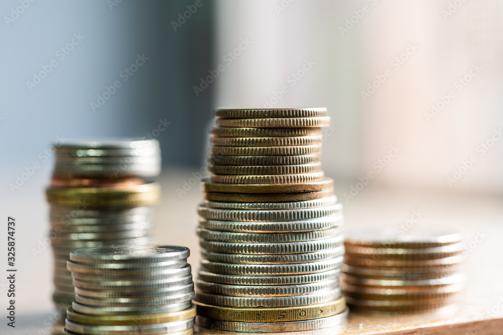 Group of coins on blurred background in business concept. Group of coins on blurred background in business concept.