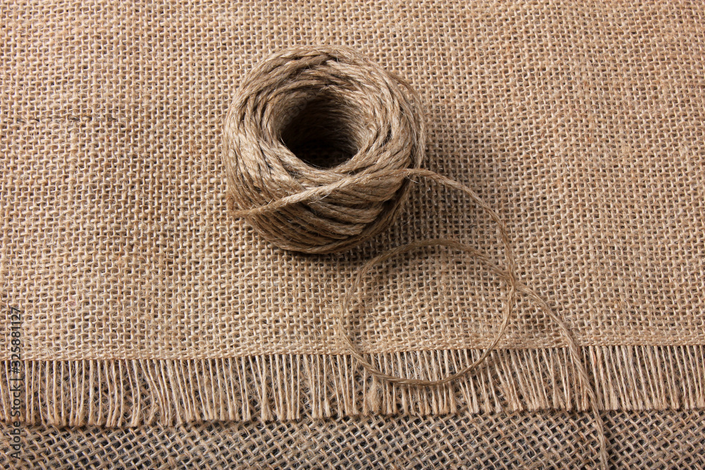 Linen rope roll and natural linen fabric texture. Linen rope roll and natural linen fabric texture.