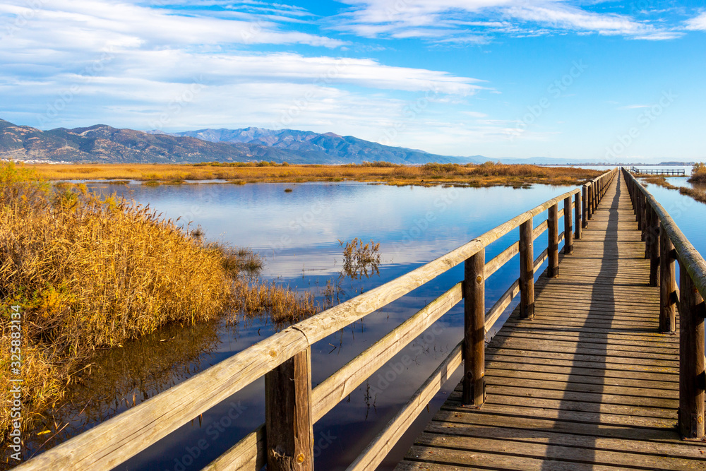 Naklejka premium Nature wooden boardwalk in Lake Vistonida, Porto Lagos, Xanthi regional unit, Greece on a sunny winter day
