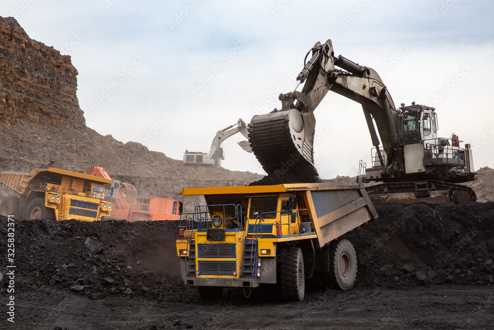Loading coal into a truck with an excavator. Mine