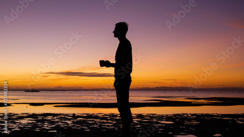 silhouette of a woman on the beach at sunset