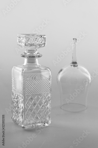 Isolated transparent empty glass botle and a glass