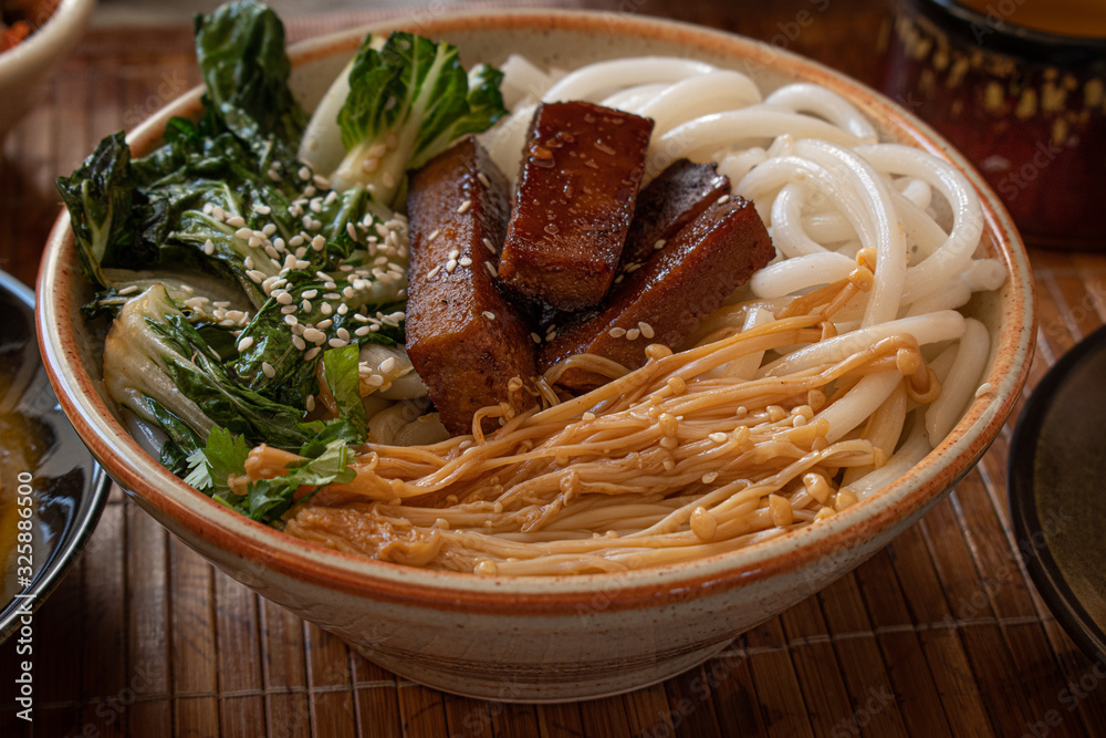 Korean rice noodle bowl with stir fried enoki, seitan beef and bok choy Stock Photo Adobe Stock