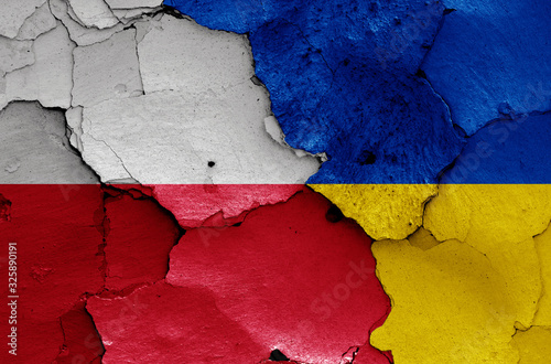 flags of Poland and Ukraine painted on cracked wall