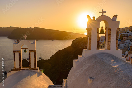 Bell tower with warm sunset light in Oia, Santorini, Greece