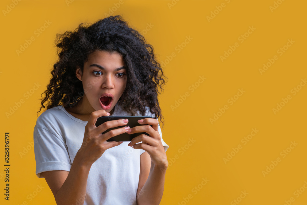 Portrait of attractive young african american girl using mobile phone