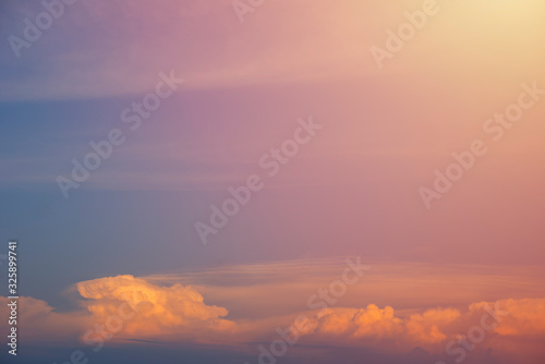 Beautiful sunset sky and clouds with dramatic light, Twilight sky and sun rays, Orange and red sky background with light of the sun-Image © DSM