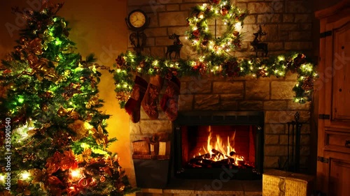 Majestic 4k shot of firewood flame burning fireplace loop in cosy festive Christmas tree New Year decoration Noel room