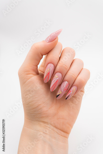 beautiful female hand with pink nails and colorful line design