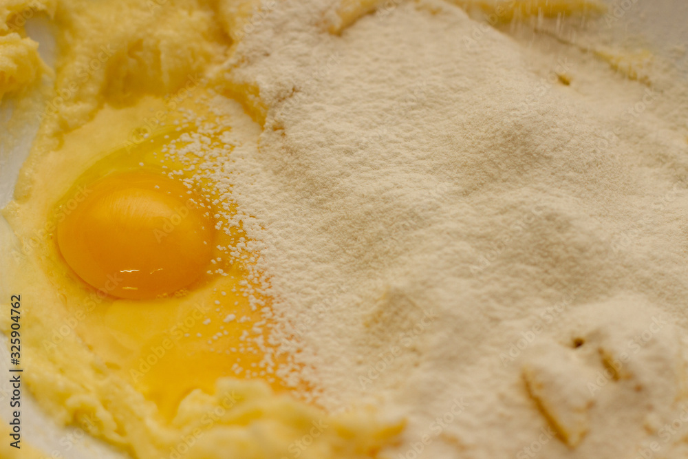 Egg yolk in flour with sugar. Baking dough for shortbread Egg yolk in flour with sugar. Baking dough for shortbread