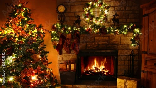 Magnificent 4k shot of firewood flame burning fireplace loop in cosy lovely Christmas tree New Year decoration Noel room