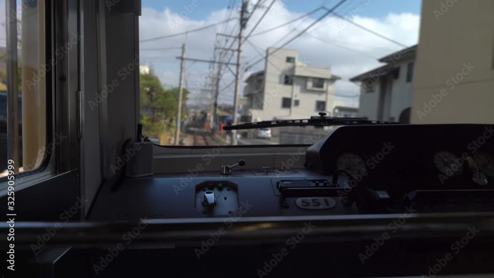 View Of Buildings And Green Trees Inside The Cabin Of A Train Driving On The Railway Of Enoshima Dentetsu Line In A Japanese Town In Japan - Wide Shot View Of Buildings And Green Trees Inside The Cabin Of A Train Driving On The Railway Of Enoshima Dentetsu Line In A Japanese Town In Japan - Wide Shot