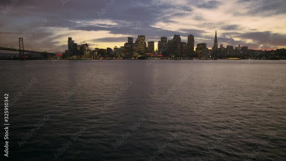 Incredible aerial drone flight over calm ocean river in San Francisco evening light downtown skyline sunset cityscape Incredible aerial drone flight over calm ocean river in San Francisco evening light downtown skyline sunset cityscape