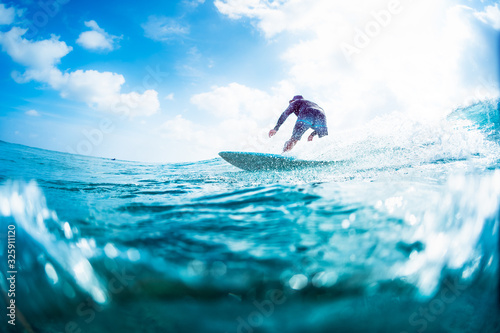 Surfer rides the ocean wave on Sultans surf spot in Maldives