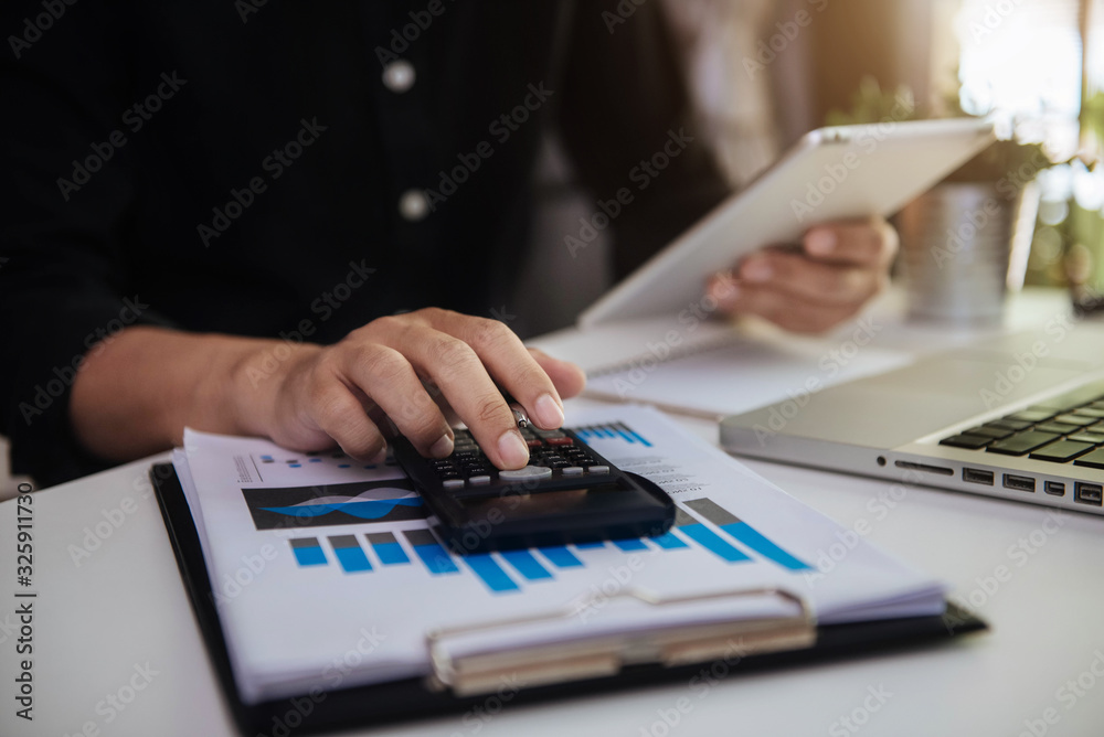 Hand male doing finances and calculate on desk about cost at home office. Hand male doing finances and calculate on desk about cost at home office.