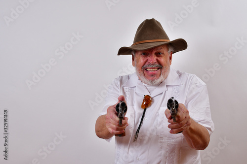 You're fired!.Furious old man aims his six shooters at you.Elderly gentleman is really pissed at you.Senior man has a hard way of firing people. photo