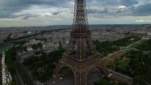 Beautiful aerial drone shot of Eiffel Tower national symbol Paris France Champ de Mars steel monument cloudy cityscape