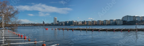 View from the Stockholm district Traneberg over the bay Ulvsundasjön sourunded by the town Solna and the district Kristineberg, Johannelund jetty, pier and bouys a sunny winter day photo