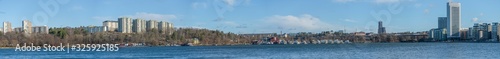 View from the Stockholm district Traneberg over the bay Ulvsundasjön surrounded by the town Solna and the district Kristineberg, jetty, pier and buoys a sunny winter day. © Hans Baath