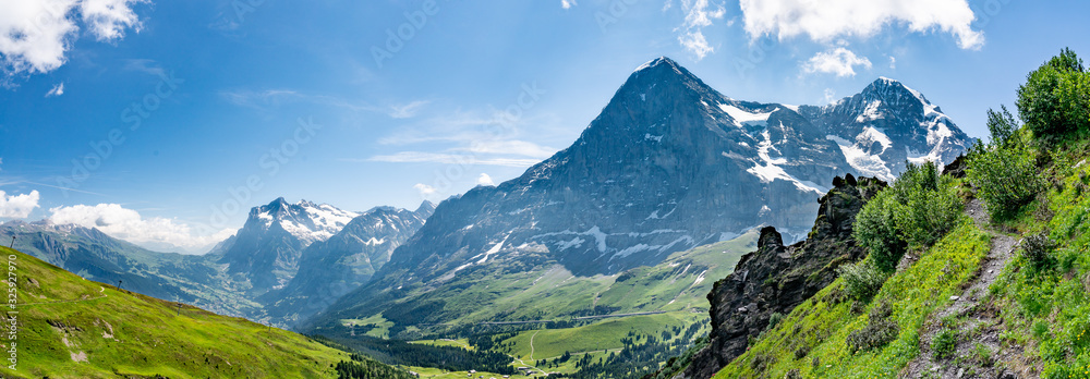 Switzerland, Panoramic view on Eiger, Monch and Yungfrau and green Alps around Mannlichen