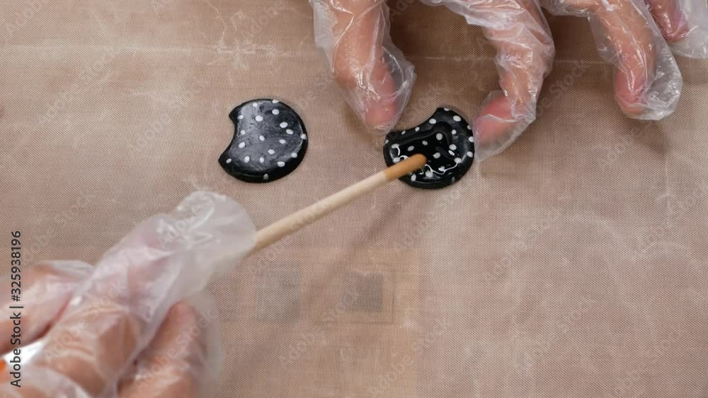 Process of creating jewelry in creative studio. Woman applies paint on ceramic jewelry. Young girl making unique handmade jewelry. Jewelry designer working in studio with tools and materials. Process of creating jewelry in creative studio. Woman applies paint on ceramic jewelry. Young girl making unique handmade jewelry. Jewelry designer working in studio with tools and materials.