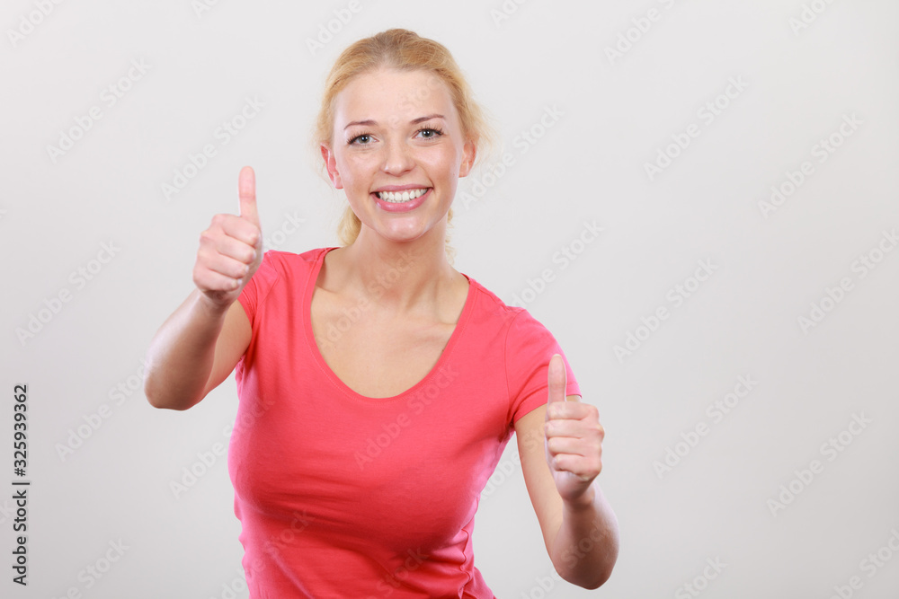 Happy woman showing thumbs up gesture Happy woman showing thumbs up gesture
