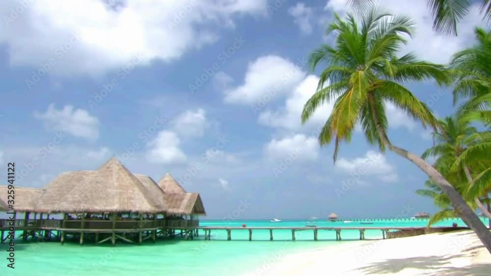 Amazing steady shot of luxury resort bungalow hotel apartment in turquoise clear ocean tropical paradise Maldives island