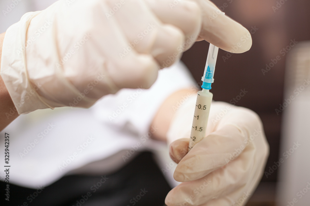 coronavirus vaccination. doctor holds a syringe with a vaccine from covid-2019, ncov-2019, SARS coronavirus vaccination. doctor holds a syringe with a vaccine from covid-2019, ncov-2019, SARS