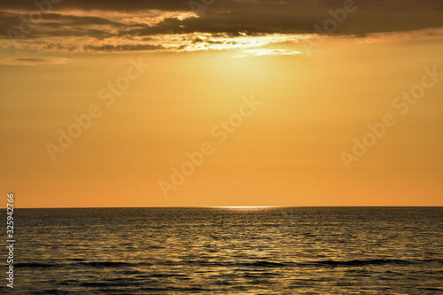 Reflection of the sun at sunrise at sea.