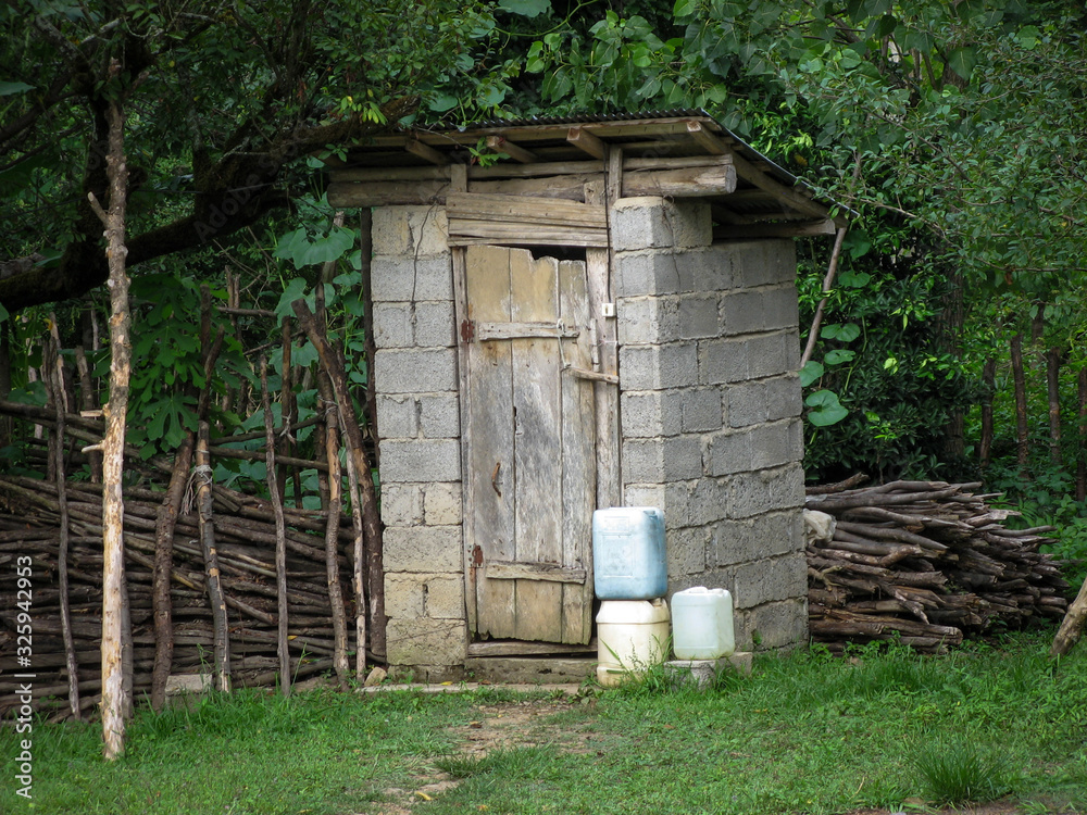 Rural lifestyle, Rustic Wc. Rustic outdoor toilet stands in the garden. Rural lifestyle, Rustic Wc. Rustic outdoor toilet stands in the garden.