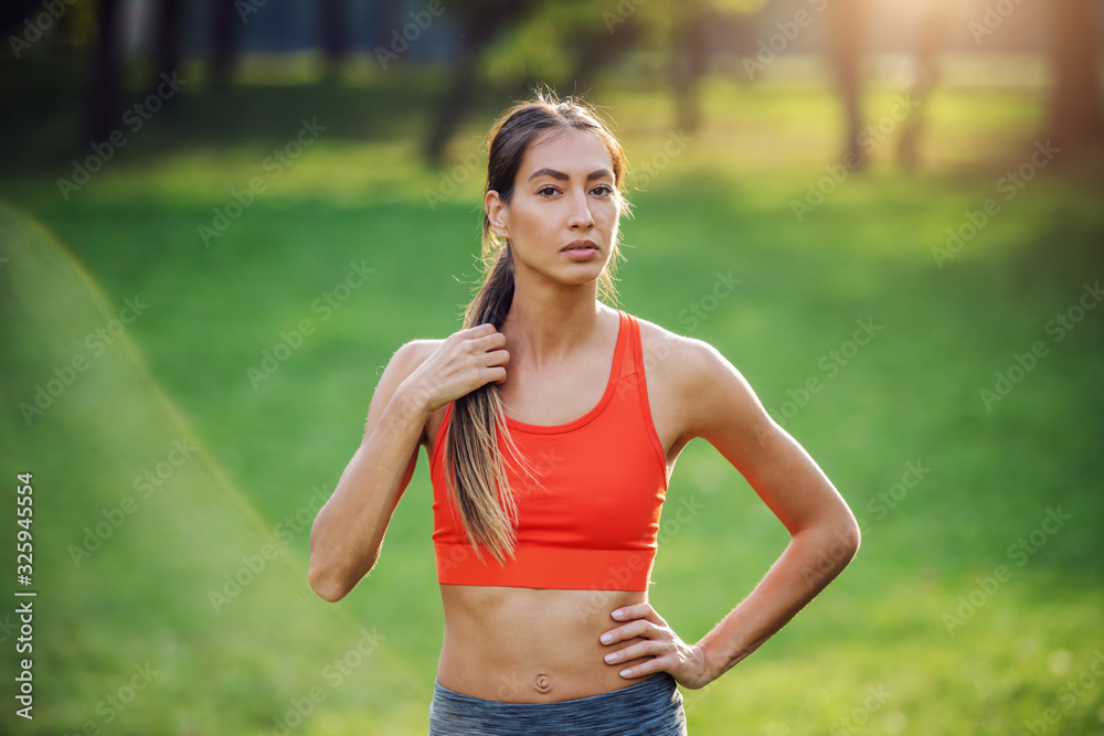 Portrait of young pensive gorgeous fit sportswoman posing in nature. Morning time.