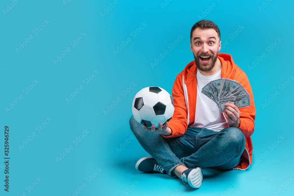 Young attractive bearded man celebrating victory after betting at bookmaker's website Young attractive bearded man celebrating victory after betting at bookmaker's website