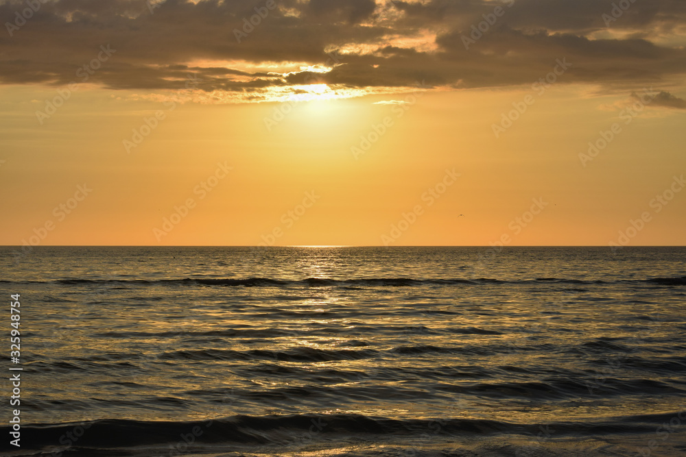 Golden sunrise at sea background, USA.