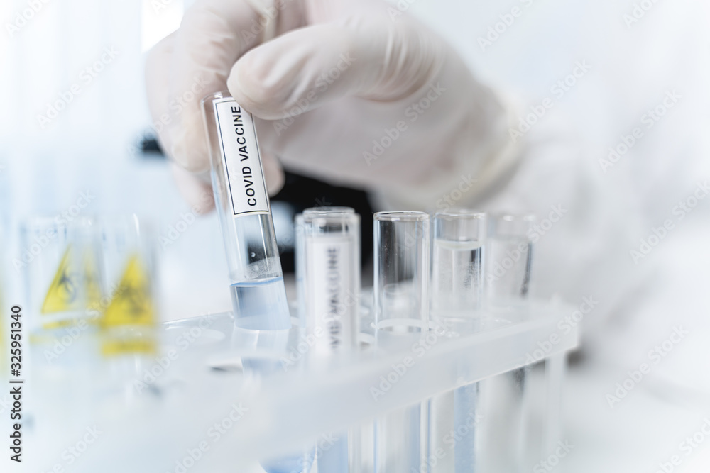 Competent scientist working at COVID vaccine in lab Competent scientist working at COVID vaccine in lab