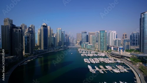 Picturesque 4k aerial drone panorama flight in clear blue sky over modern urban architecture of Dubai big city cityscape