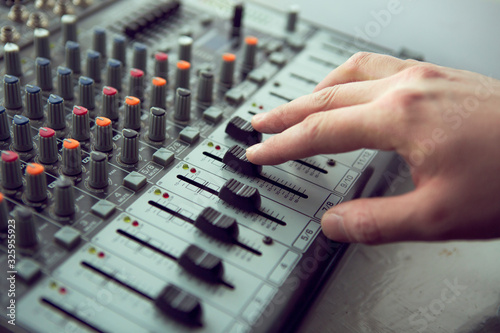 An expert adjusting audio mixing console. Music Studio
