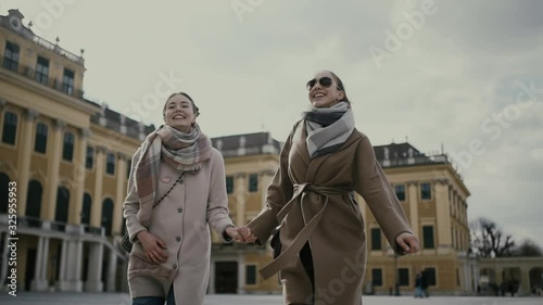 Two young girls tourists walk and enjoy together in Vienna (Europe, Austria).