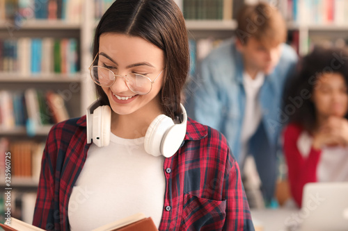 Female student reading book...