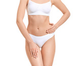 Young woman in underwear on white background. Concept of plastic surgery