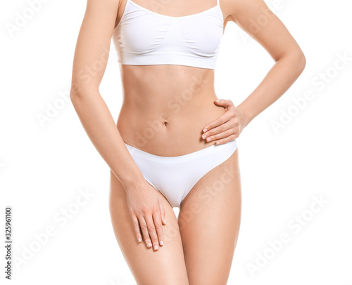 Young woman in underwear on white background. Concept of plastic surgery