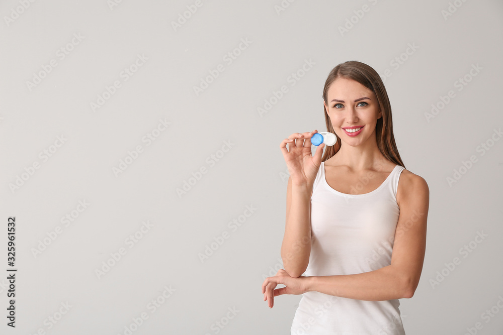Woman with contact lenses on light background Woman with contact lenses on light background