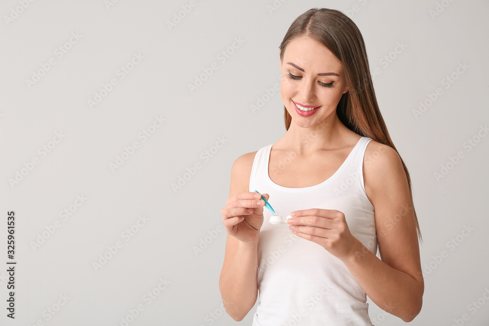 Woman with contact lenses on light background Woman with contact lenses on light background