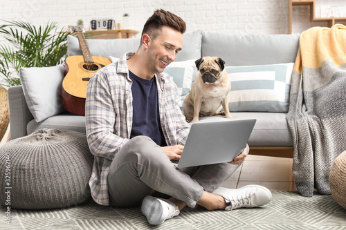 Handsome man with laptop an...