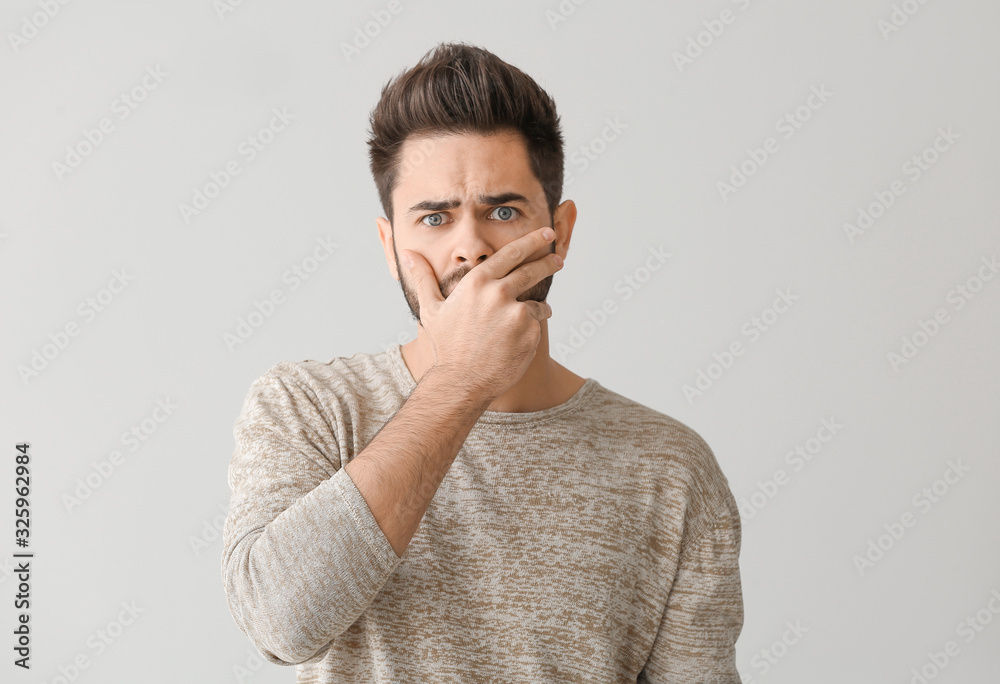 Portrait of worried young man on light background Portrait of worried young man on light background