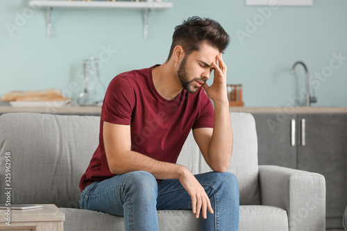 Tableau sur toile Portrait of worried young man at home