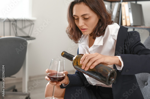 Woman drinking wine at home...