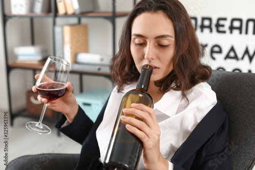 Woman drinking wine at home...