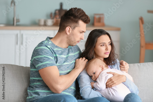 Young father with baby and ...