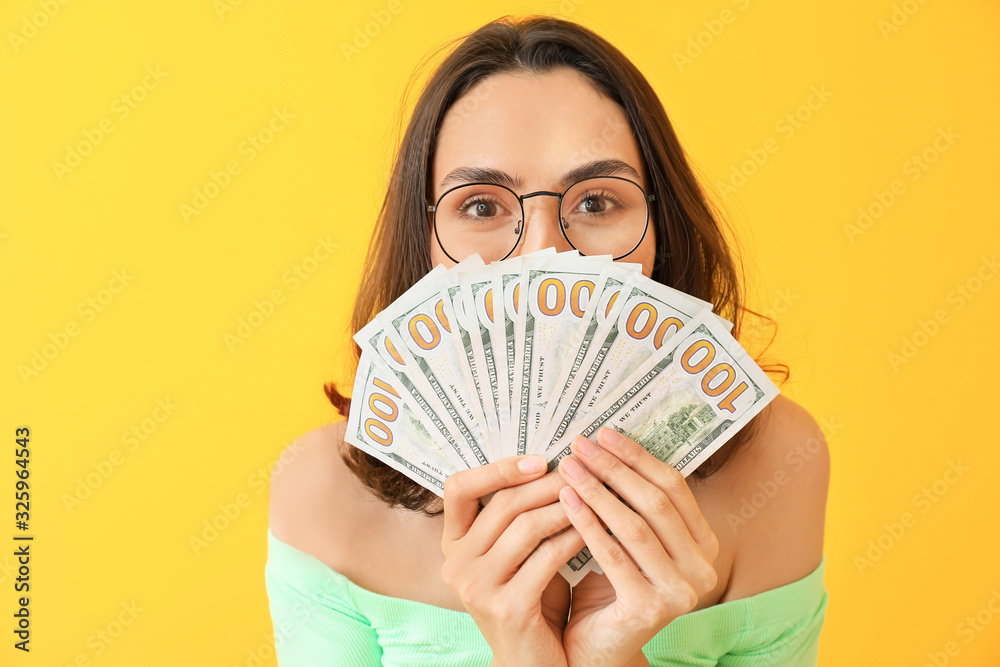Beautiful young woman with money on color background Beautiful young woman with money on color background