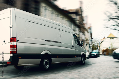 Fast delivery van in a narrow street. A challenge for logistics and transportation.